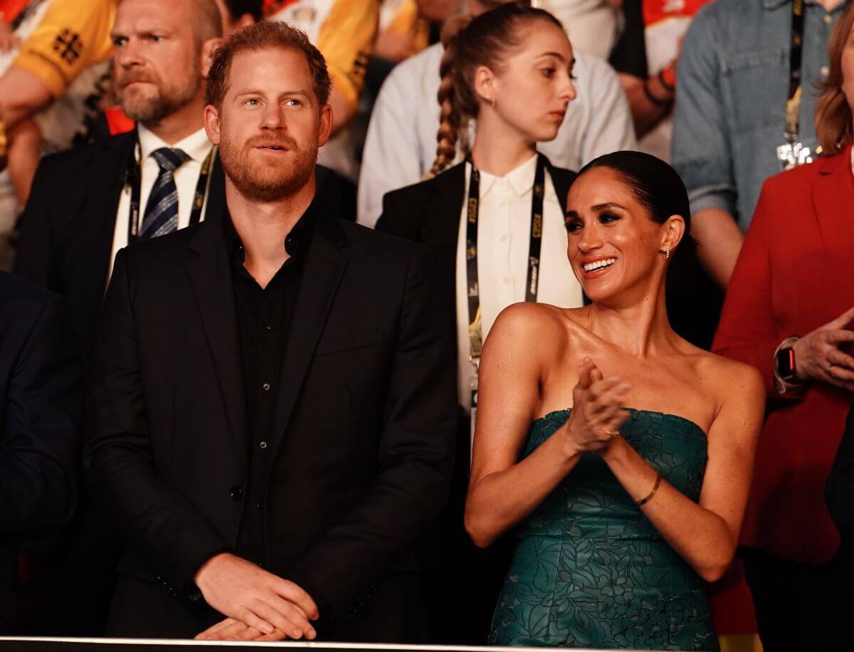 Meghan Markle, who a body language expert says 'let her hair down' on date night' with Prince Harry who 'didn't want to be there,' attend the Invictus Games 2023 closing ceremony