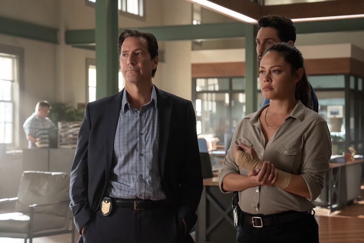 Henry Ian Cusick and Vanessa Lachey standing in an office in 'NCIS: Hawai'i'
