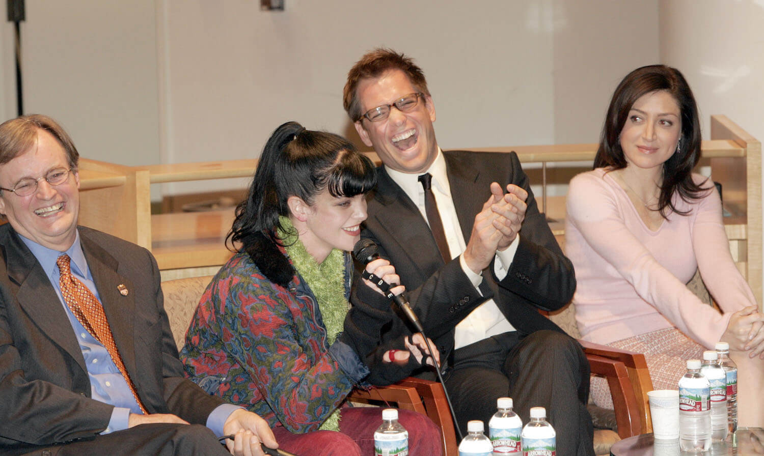 'NCIS' actors David McCallum, Pauley Perrette, Michael Weatherly, and Sasha Alexander laughing and talking together at a panel
