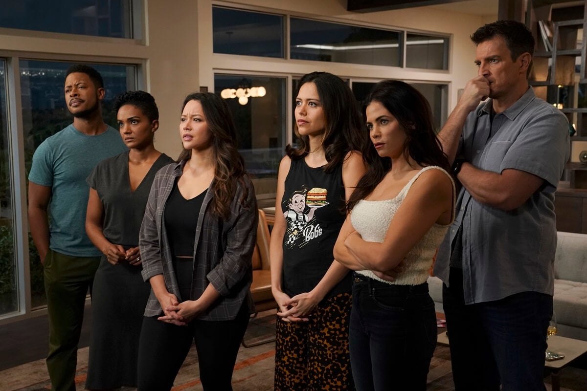 A scene in 'The Rookie' where 'Rookie' cast members ARJAY SMITH, MEKIA COX, MELISSA O'NEIL, ALYSSA DIAZ, JENNA DEWAN, NATHAN FILLION, are all standing together in a room.