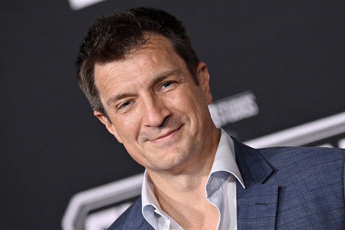 Nathan Fillion posing in a suit at the world premiere of the World Premiere of Marvel Studios' "Guardians of the Galaxy Vol. 3".