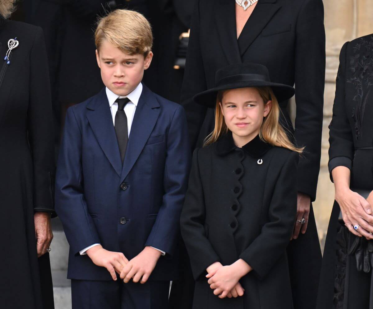 Prince George and Princess Charlotte standing side by side during Queen Elizabeth II's funeral