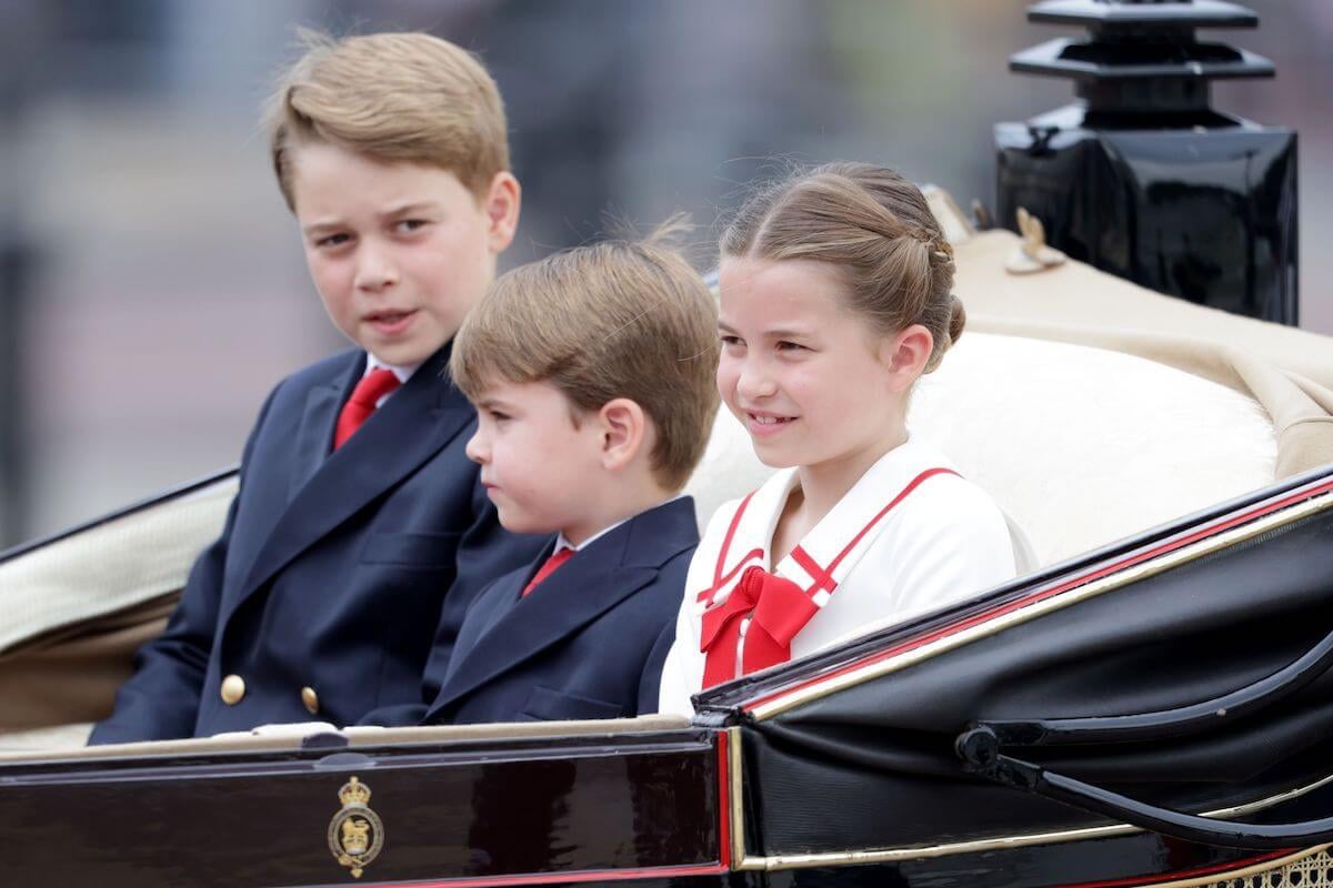 Prince George, who is more 'confident' per a body language expert, sits with Prince Louis and Princess Charlotte