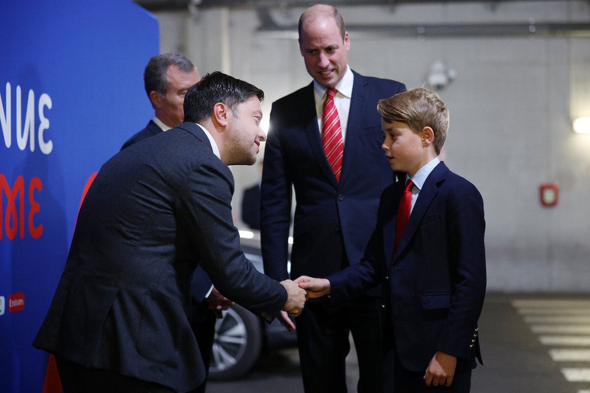 Prince George, whose more 'confident,' per a body language expert, shakes hands with Benoit Payan.