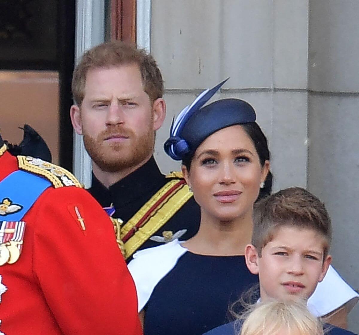 Prince Harry and Meghan Markle members of the Royal Family on the balcony of Buckingham Palace