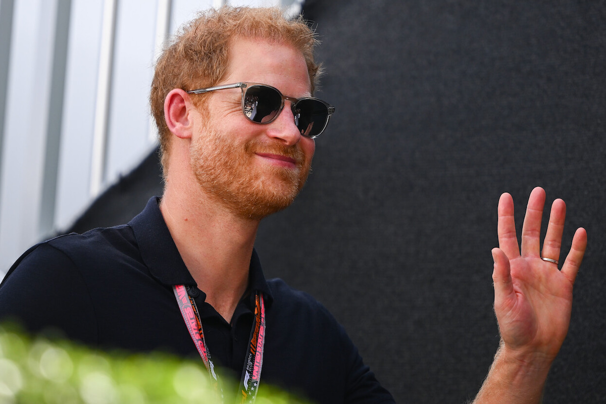 Prince Harry smiles and waves while attending a Formula 1 race in Texas where, per an expert, he looked like his 'old self.'