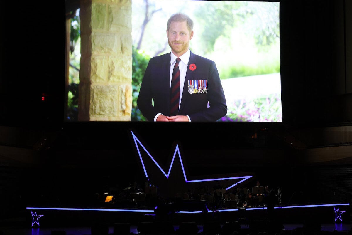 Prince Harry appears on screen in a video at the annual Stand Up for Heroes benefit