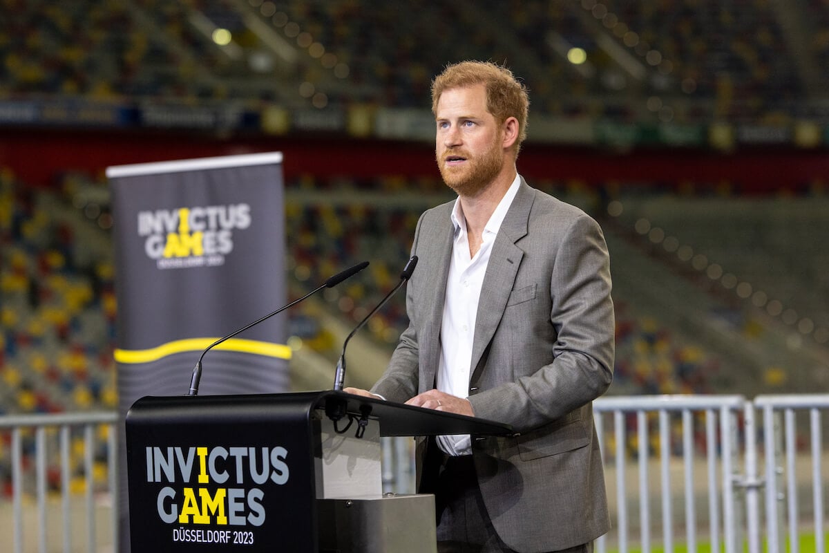 Prince Harry speaks at an Invictus Games event standing at a lectern.