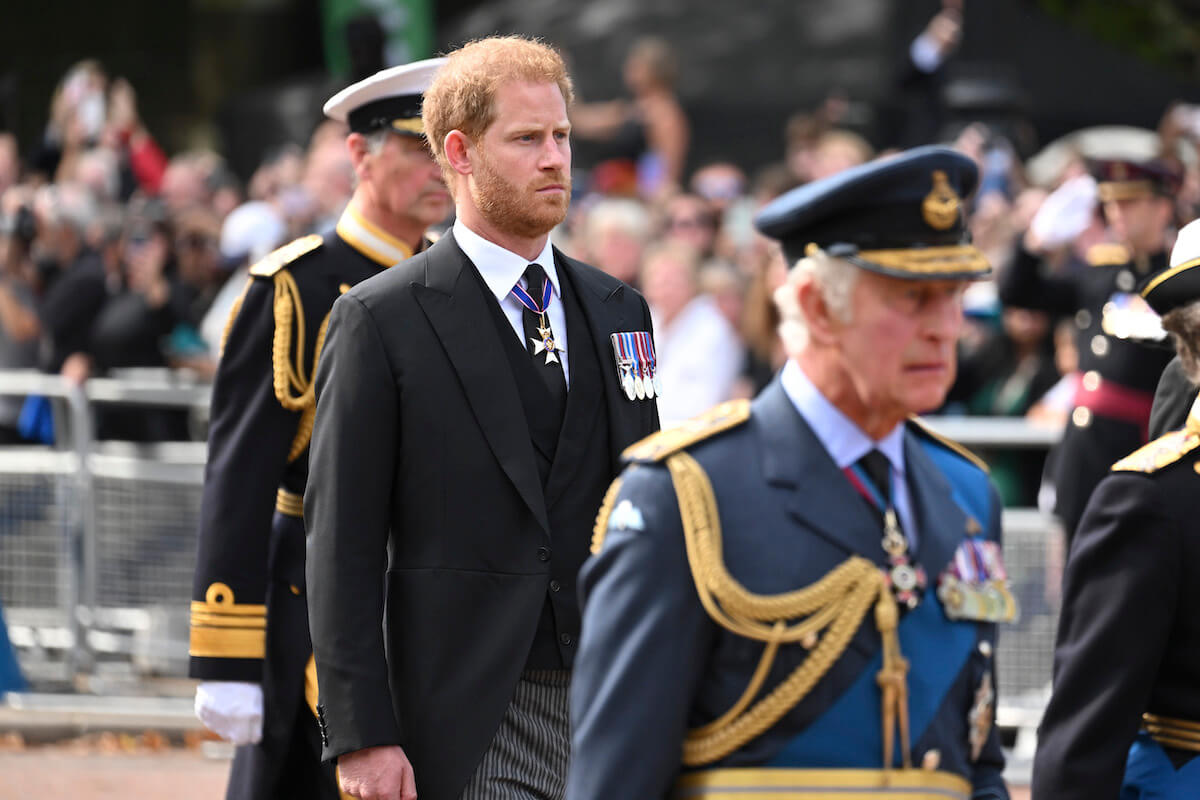Prince Harry stands behind King Charles III at Queen Elizabeth II's funeral