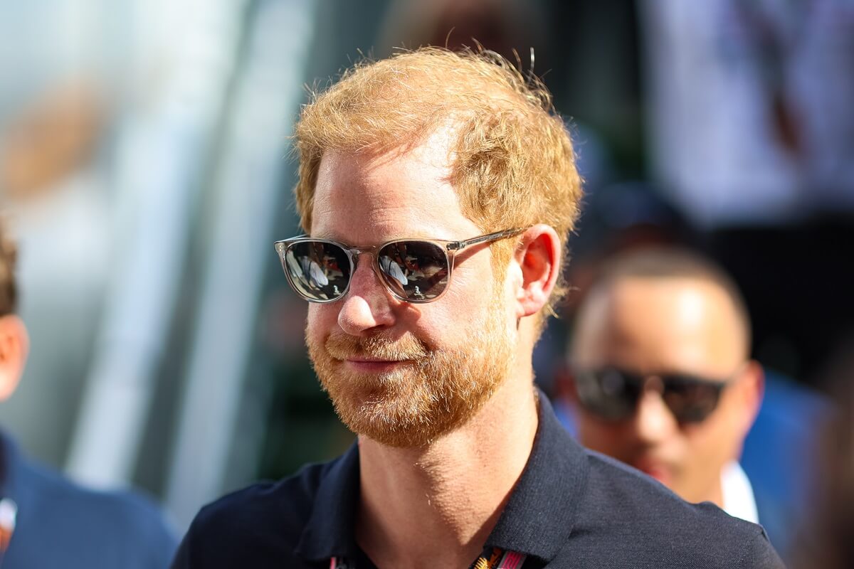 Prince Harry, who an expert says is 'lonely' and 'desperate' for a social life and 'totally dependent' on Meghan, walks in the paddock before the F1 Grand Prix of United States at Circuit of The Americas