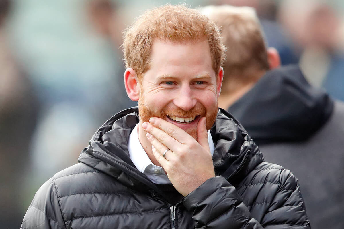 Prince Harry, who had 'tells' in a Stand Up for Heroes video, smiles and puts a hand on his chin