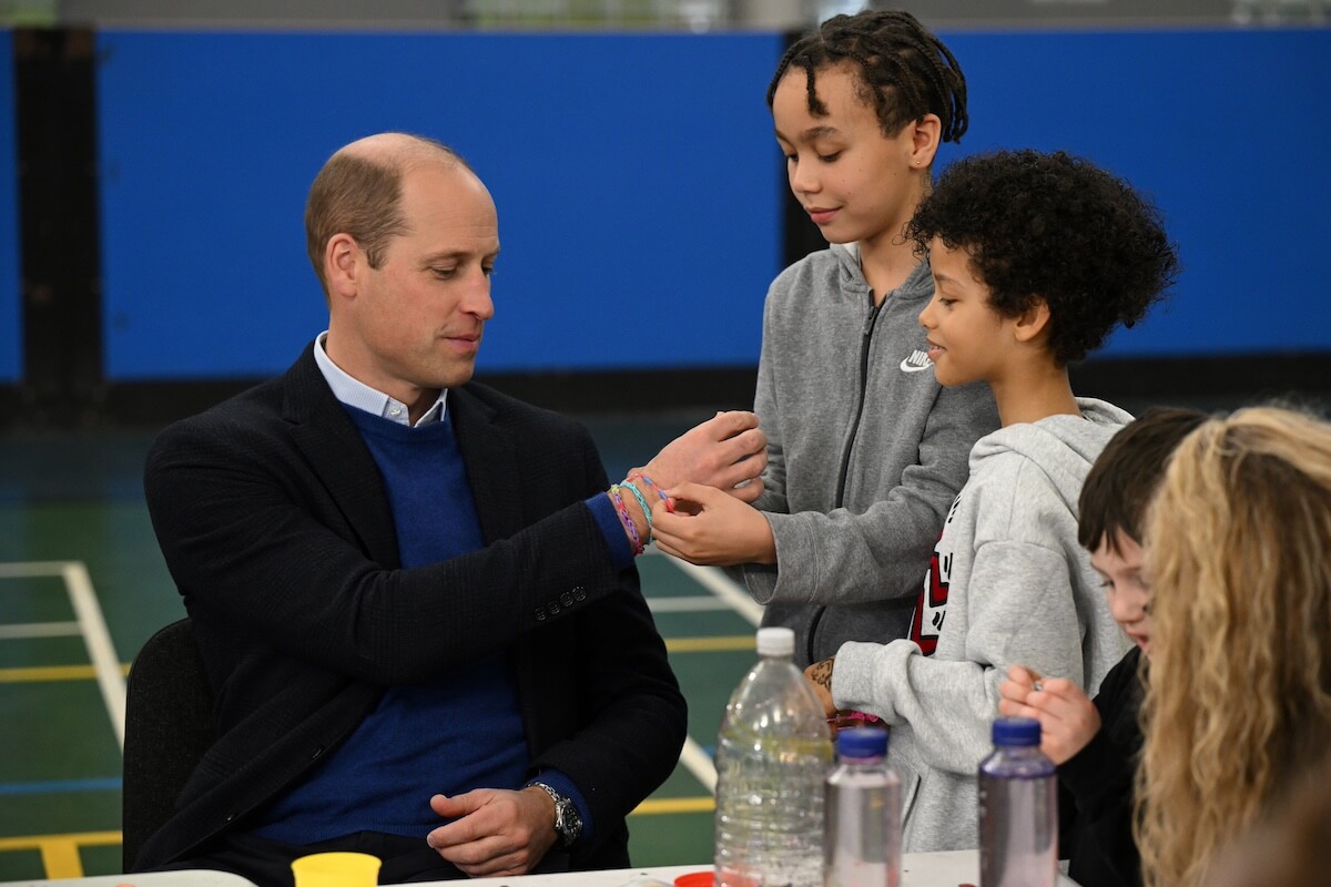 Prince William talks to children at a royal event in 2023