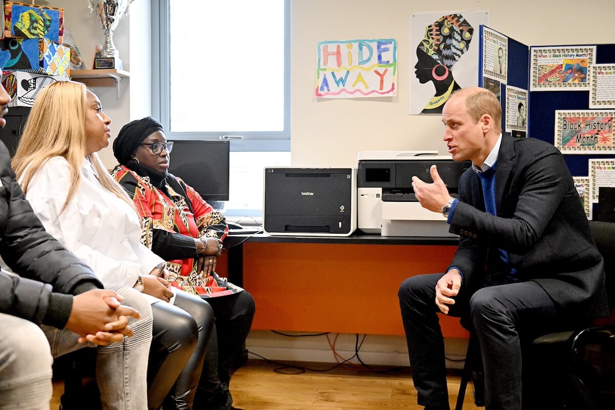 Prince William speaks with people in 2023
