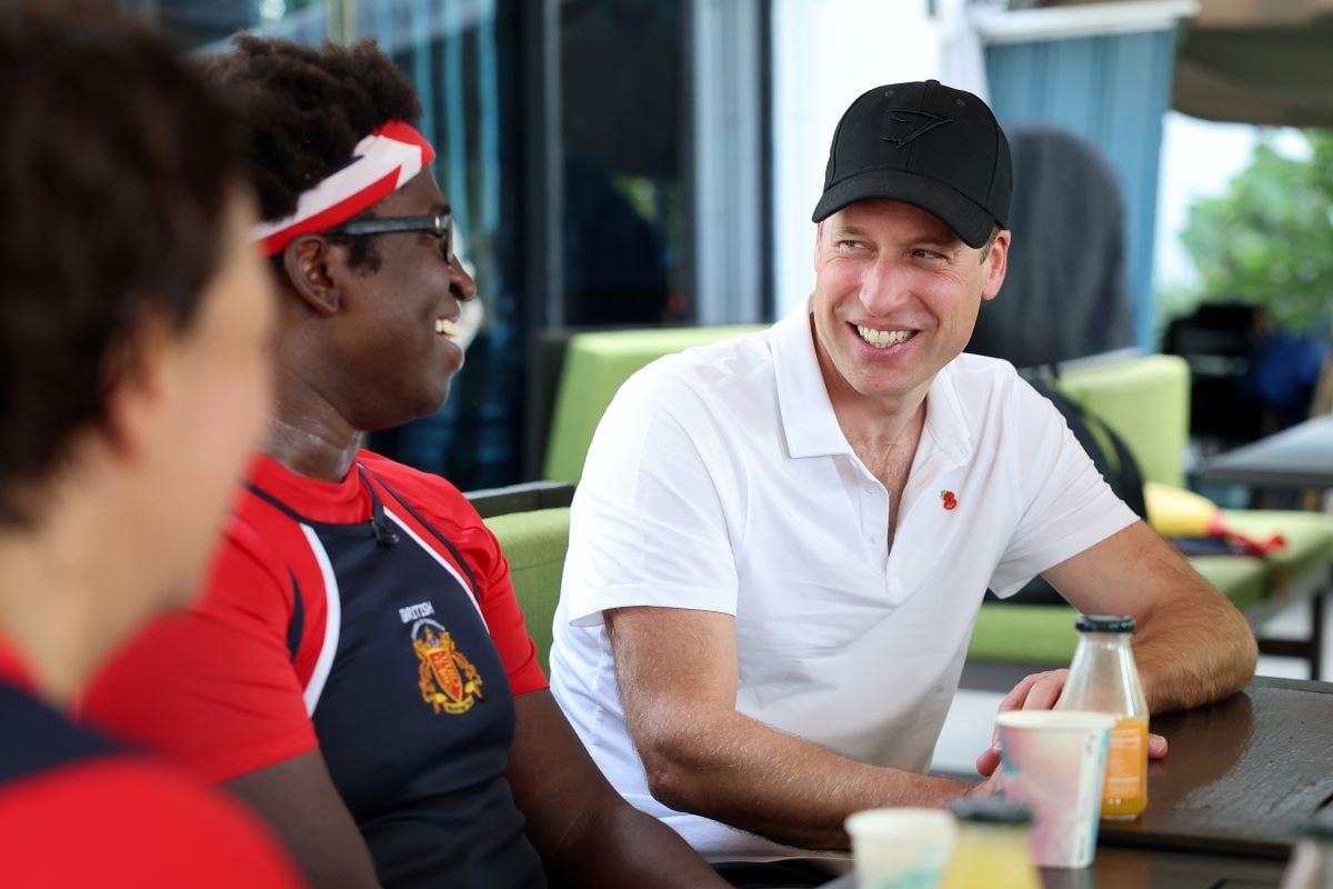 Prince William talking with members of the British Dragons dragon boating club in Singapore