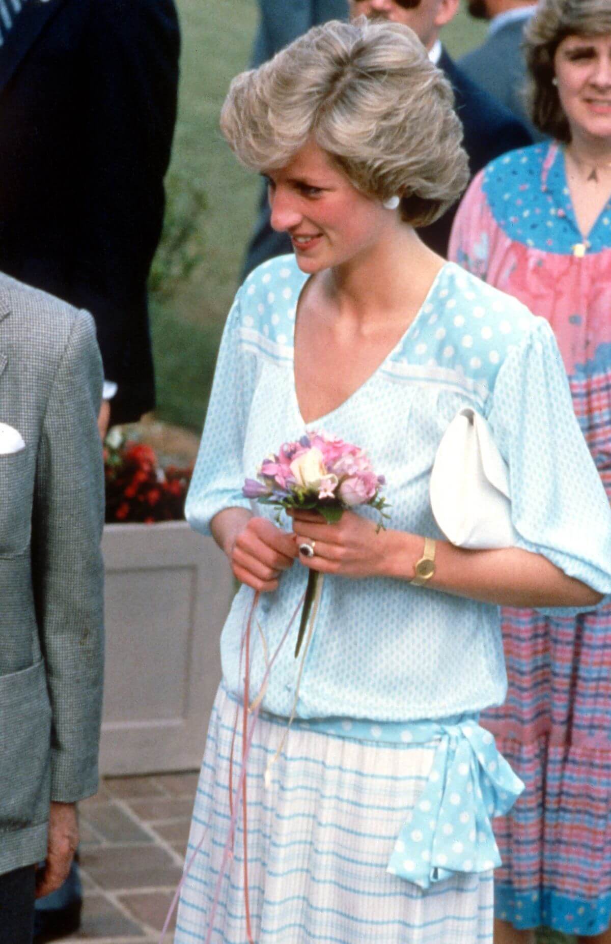 Princess Diana wearing a pale blue and white dress designed by Lady Dale Tryon aka Kanga, attends a Polo match