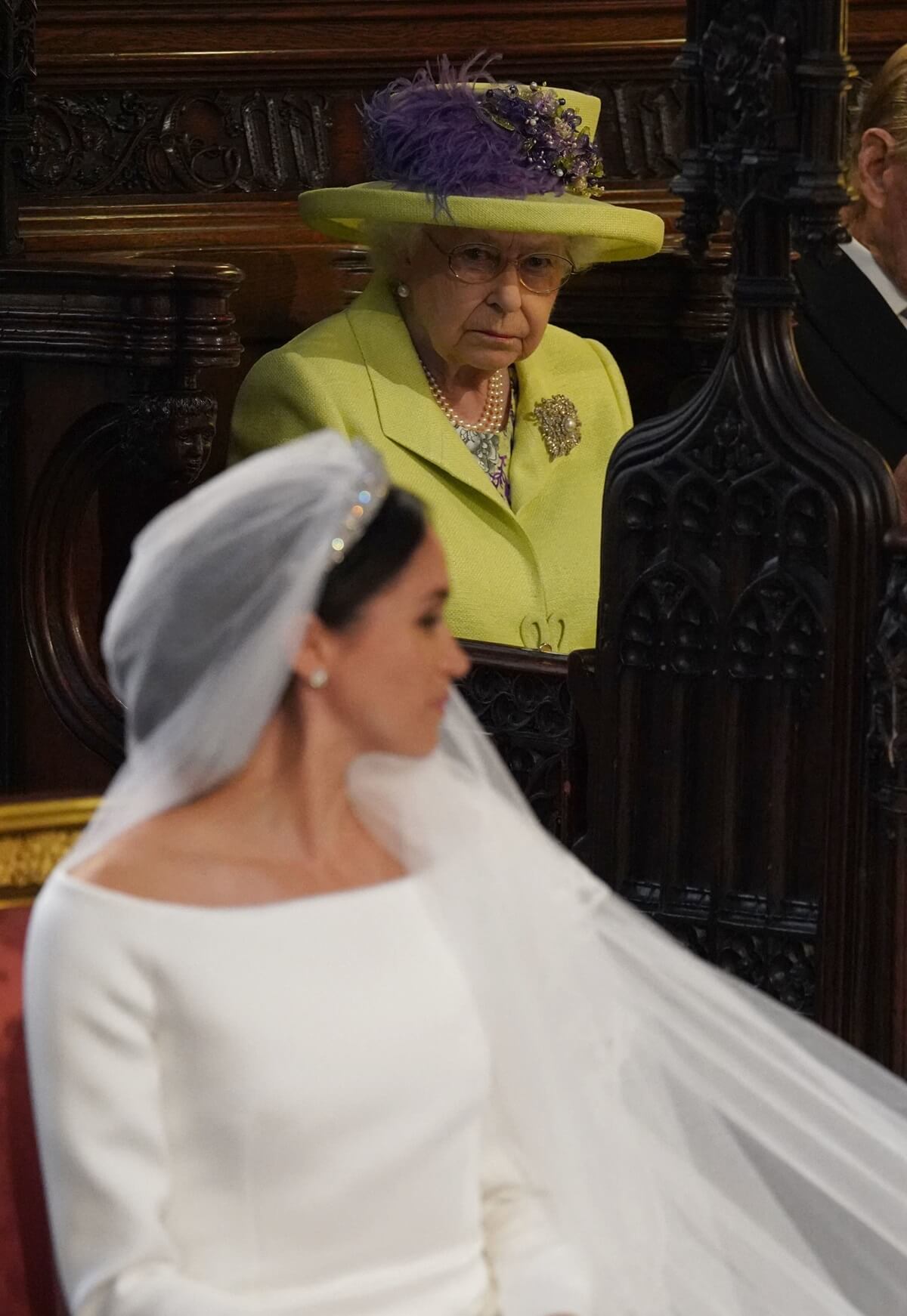 Queen Elizabeth II looks at Meghan Markle during her royal wedding to Prince Harry