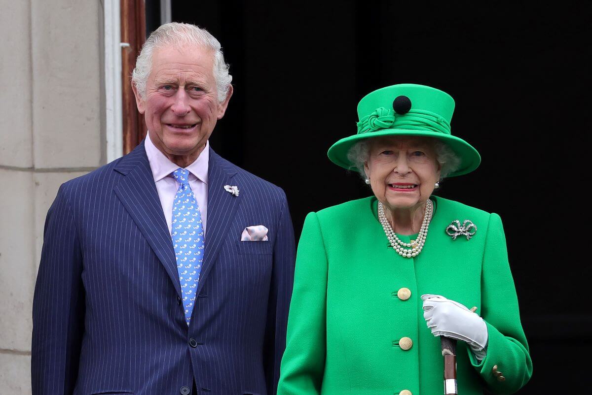 Queen Elizabeth II with her son now-King Charles III, who's new 'bodyguard' Princess Anne reminds him of their mother, standing on the balcony of Buckingham Palace during the Platinum Jubilee Pageant