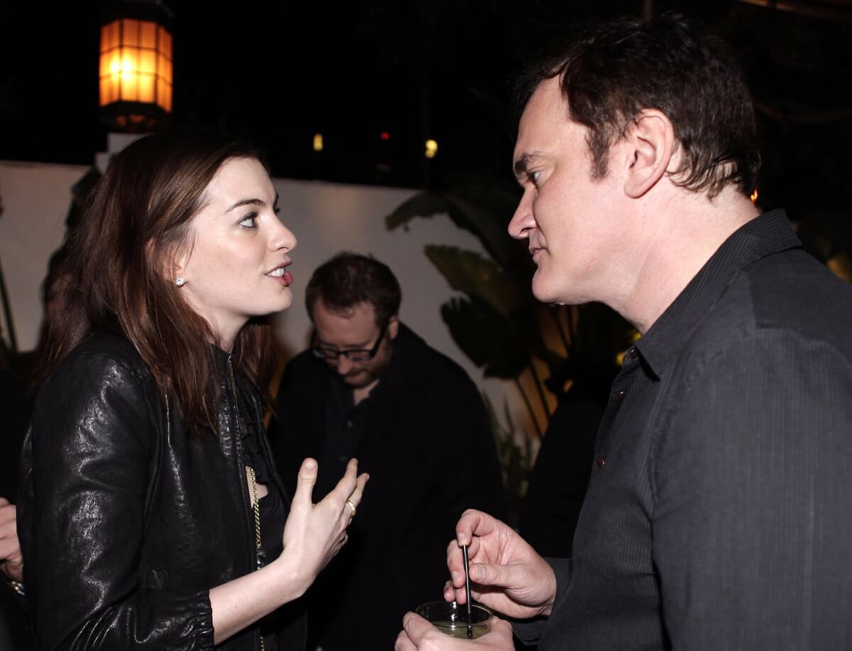 Anne Hathaway and Quentin Tarantino facing each other while at the Academy Award Nominations For "Inglourious Basterds" And Quentin Tarantino event hosted by Audi.