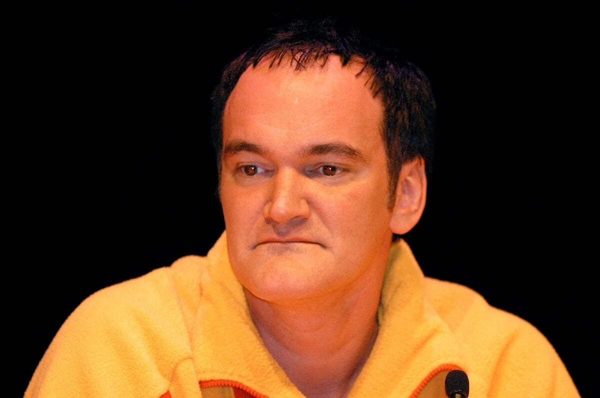 Quentin Tarantino wearing a yellow shirt at a 'Kill Bill Vol. 1' press conference.