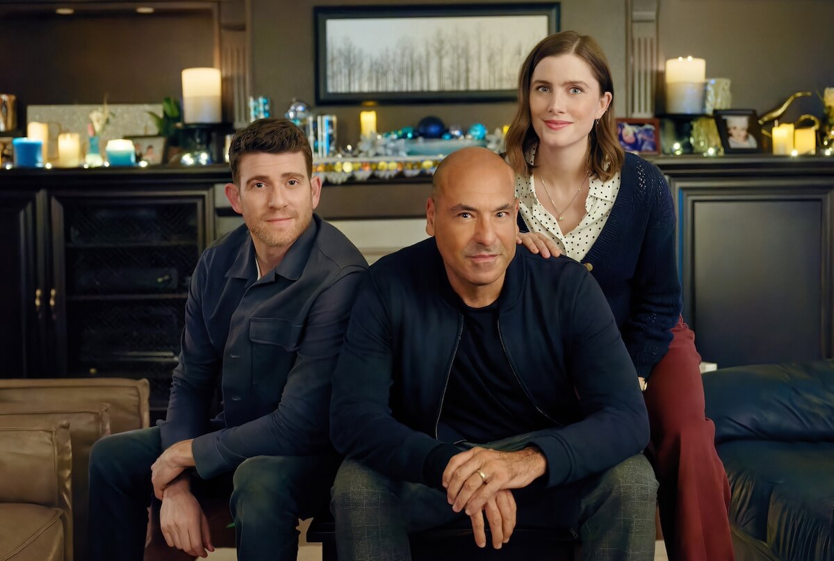 Bryan Greenberg, Rick Hoffman, Vic Michaelis posing in front of candles in the Hallmark movie 'Round and Round'