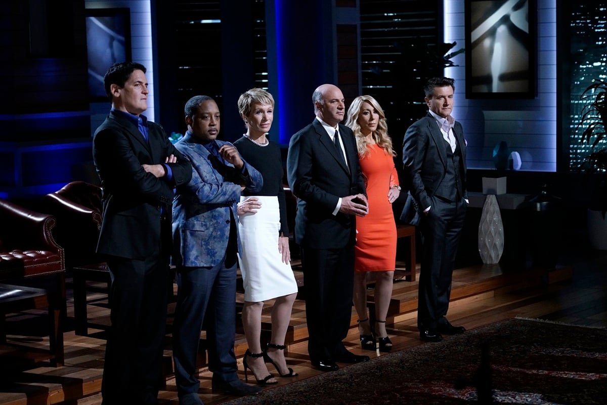 Mark Cuban, Daymond John, Barbara Corcoran, Kevin O'Leary, Lorie Greiner and Robert Herjavec stand together on the set of 'Shark Tank'
