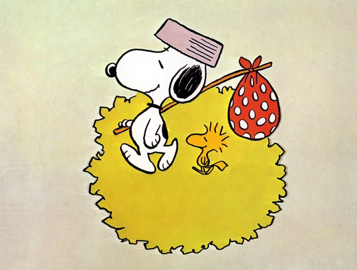 Snoopy wearing a dog bowl for a hat and carrying a bindle in 'Snoopy Come Home'