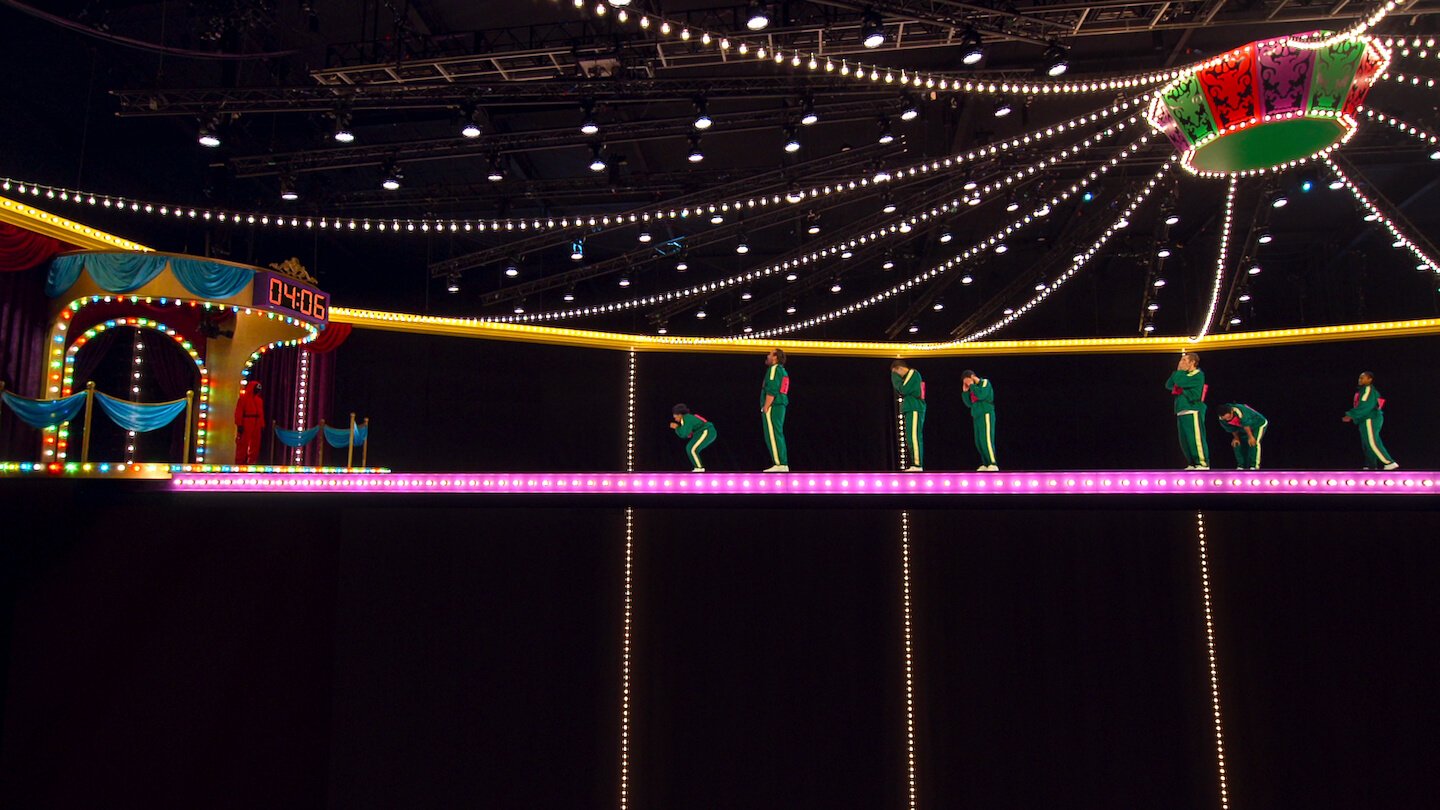 Contestants on a light-up bridge in the dark in 'Squid Game: The Challenge'
