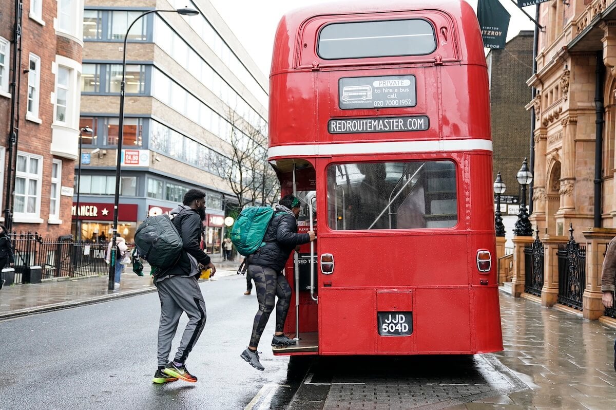 People boarding a red double-decker bus in London in 'The Amazing Race'