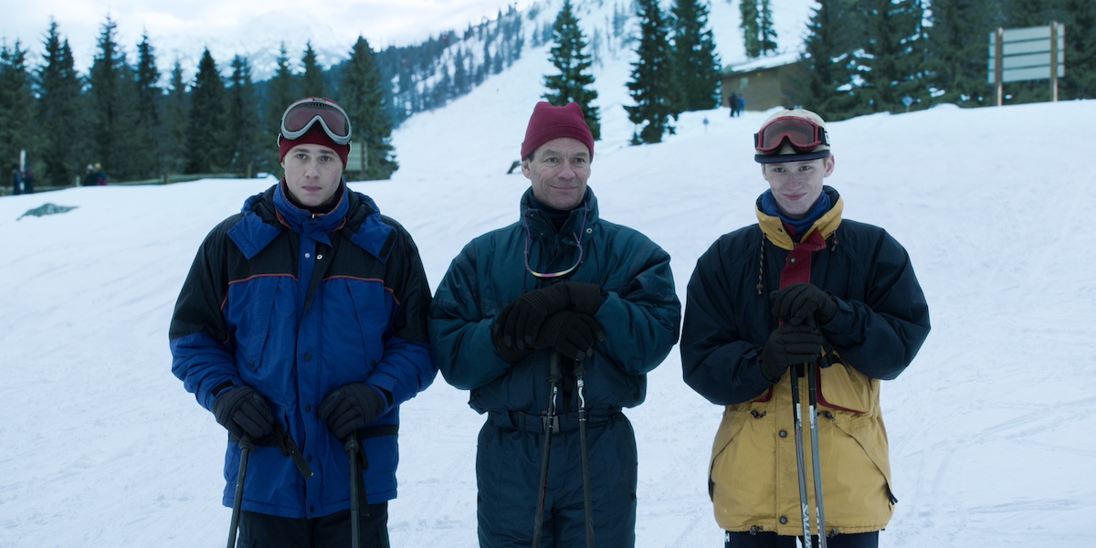 William, Charles, and Harry posing in ski attire on a mountain in 'The Crown' Season 6