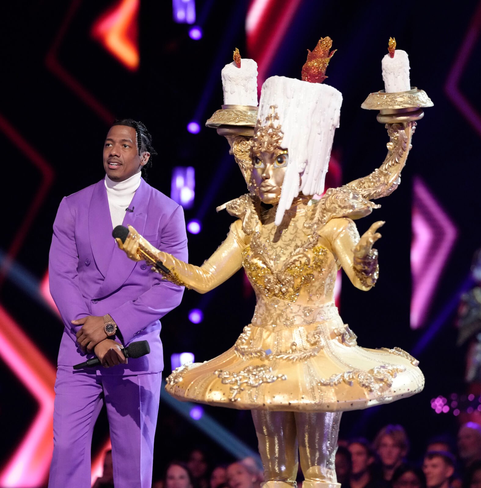 'The Masked Singer' Season 10 mask Candelabra standing next to host Nick Cannon on stage