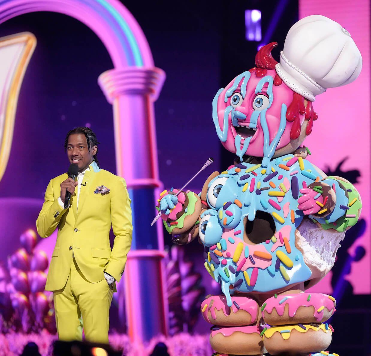 Donut in 'The Masked Singer' Season 10 standing next to host Nick Cannon