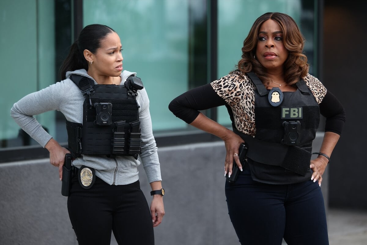 Juani Feliz and Niecy Nash-Betts wearing bulletproof vest and standing next to each other in 'The Rookie: Feds'