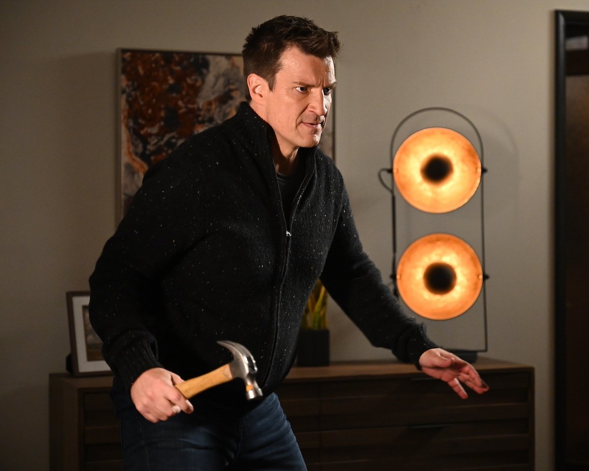 Nathan Fillion holding a hammer in 'The Rookie'