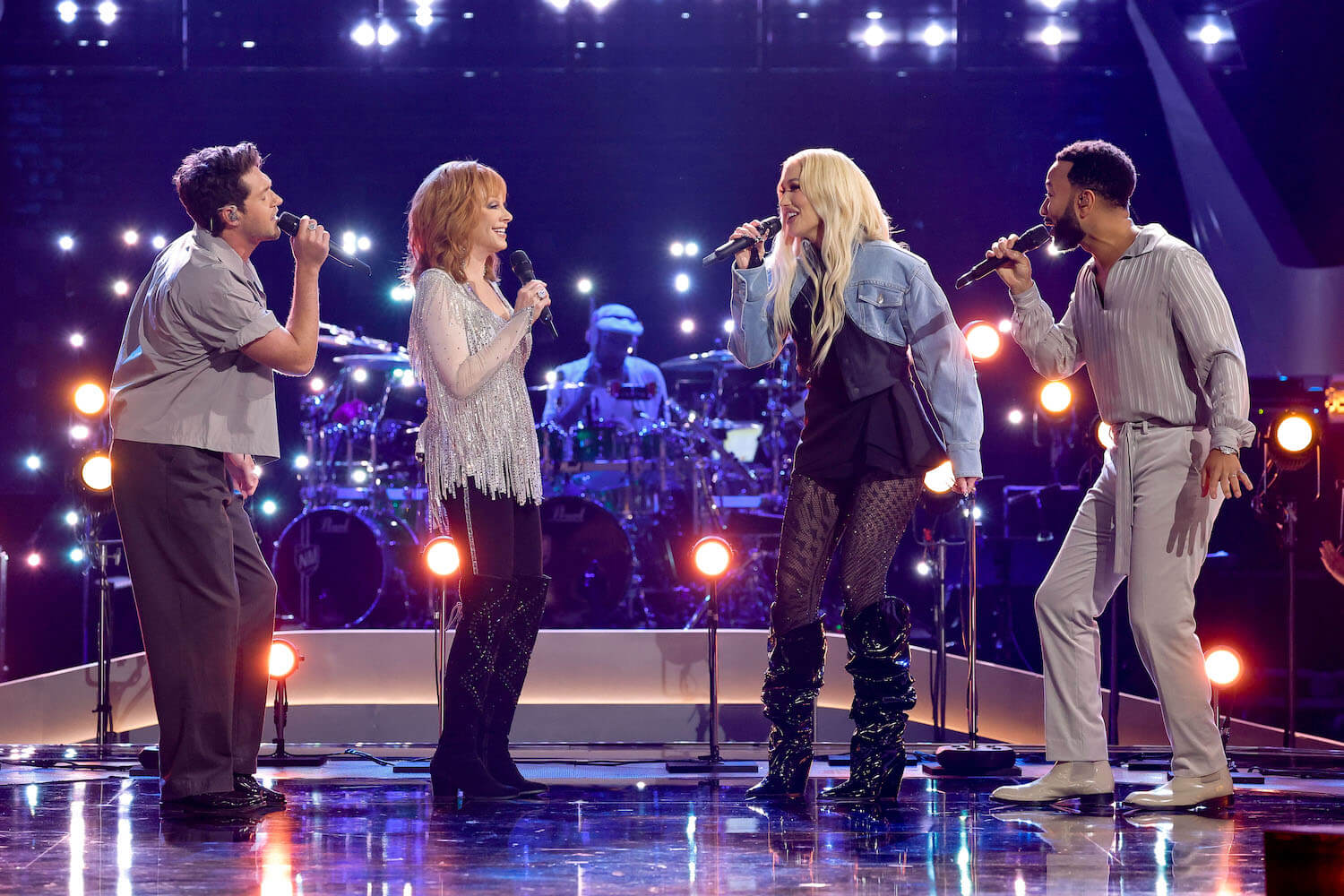 Niall Horan, Reba McEntire, Gwen Stefani, and John Legend singing on stage in 'The Voice' Season 24 before the Live Shows