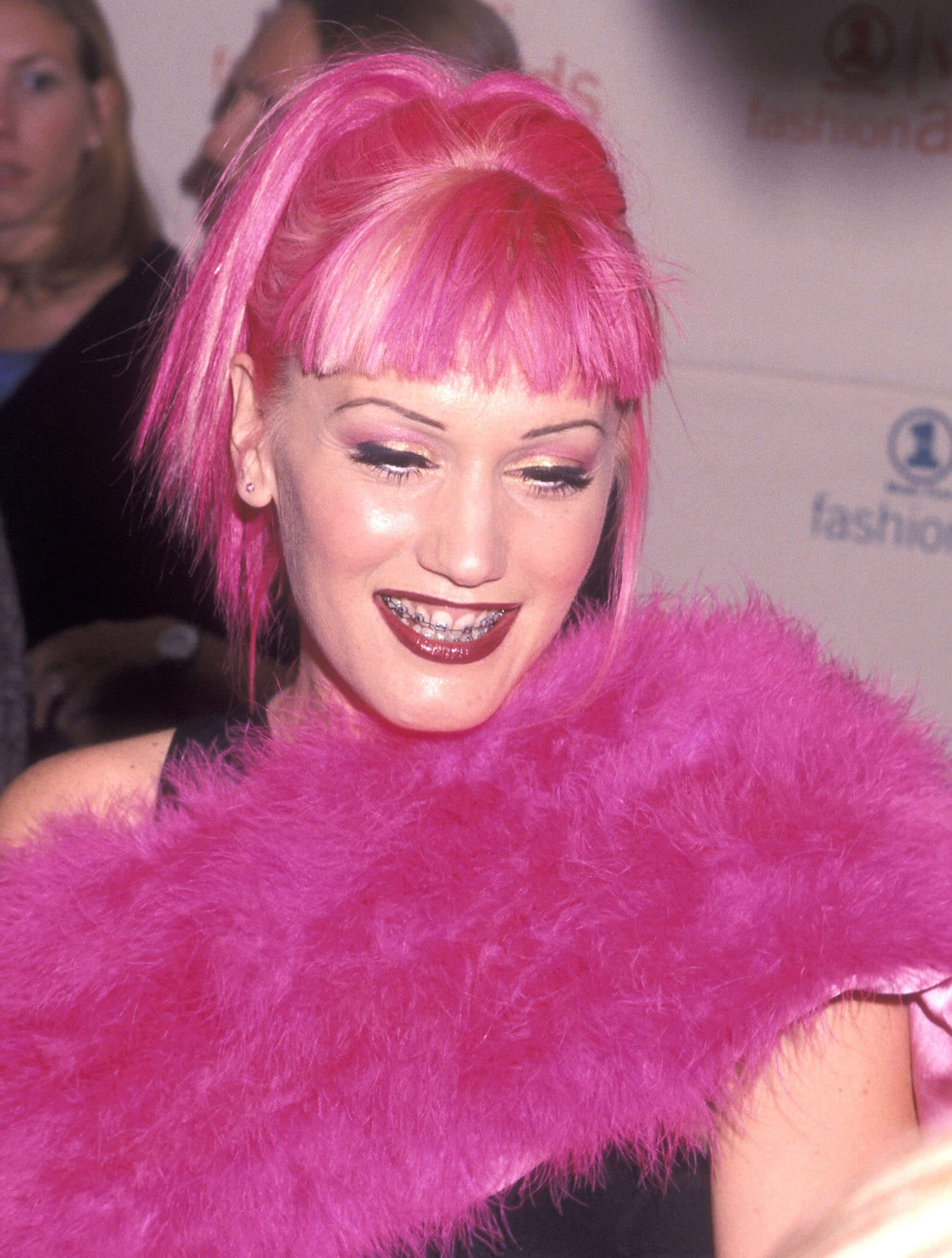 'The Voice' Season 24 coach Gwen Stefani of No Doubt attends the 1999 VH1/Vogue Fashion Awards. She has pink hair and braces.