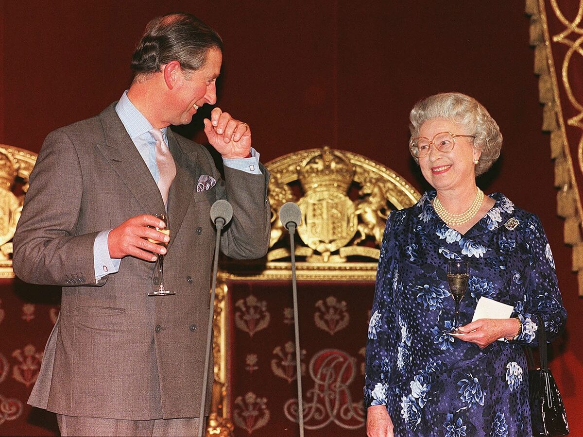 Then-Prince Charles raises his glass in response to a toast from his mother, Queen Elizabeth II, during a reception in his honor