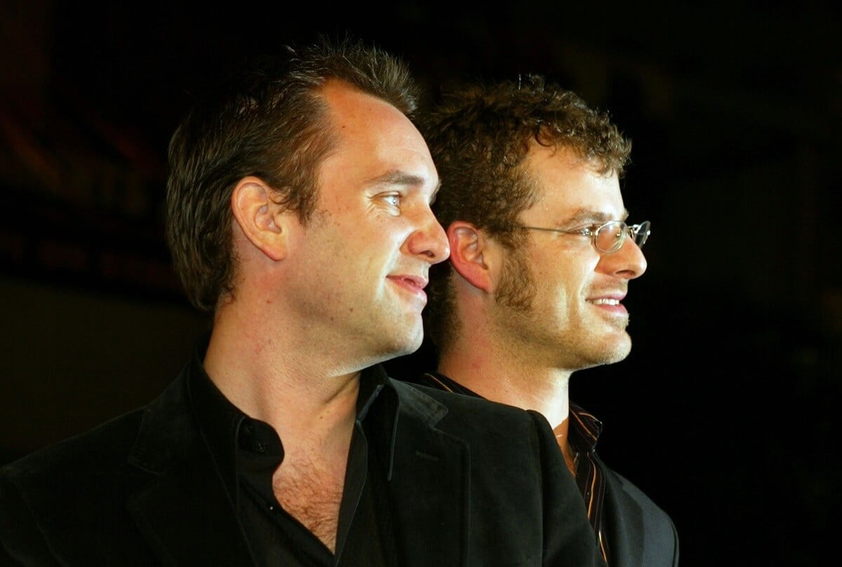 Trey Parker and Matt Stone posing at the premiere of the Los Angeles Premiere of their movie "Team America: World Police" wearing black suits.