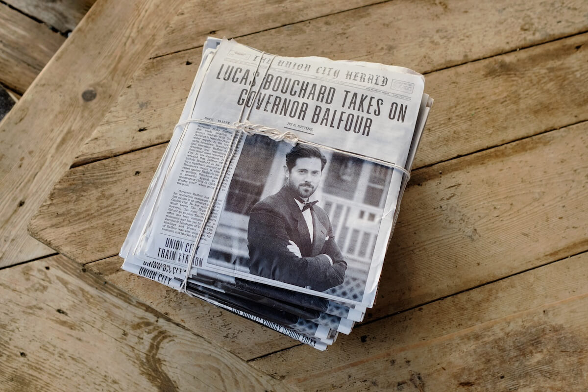 Stack of newspapers with photo of Lucas Bouchard on the front page