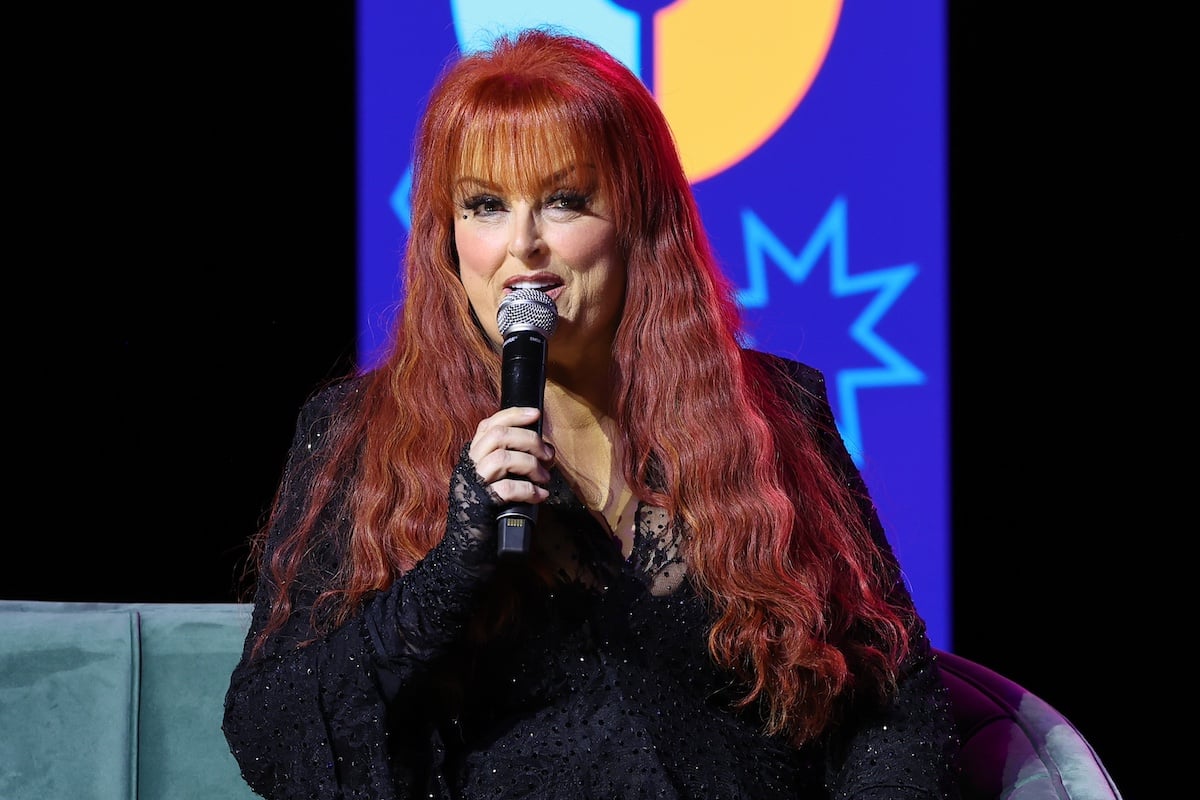 Wynonna Judd holding a microphone and speaking during CMA Fest 2023
