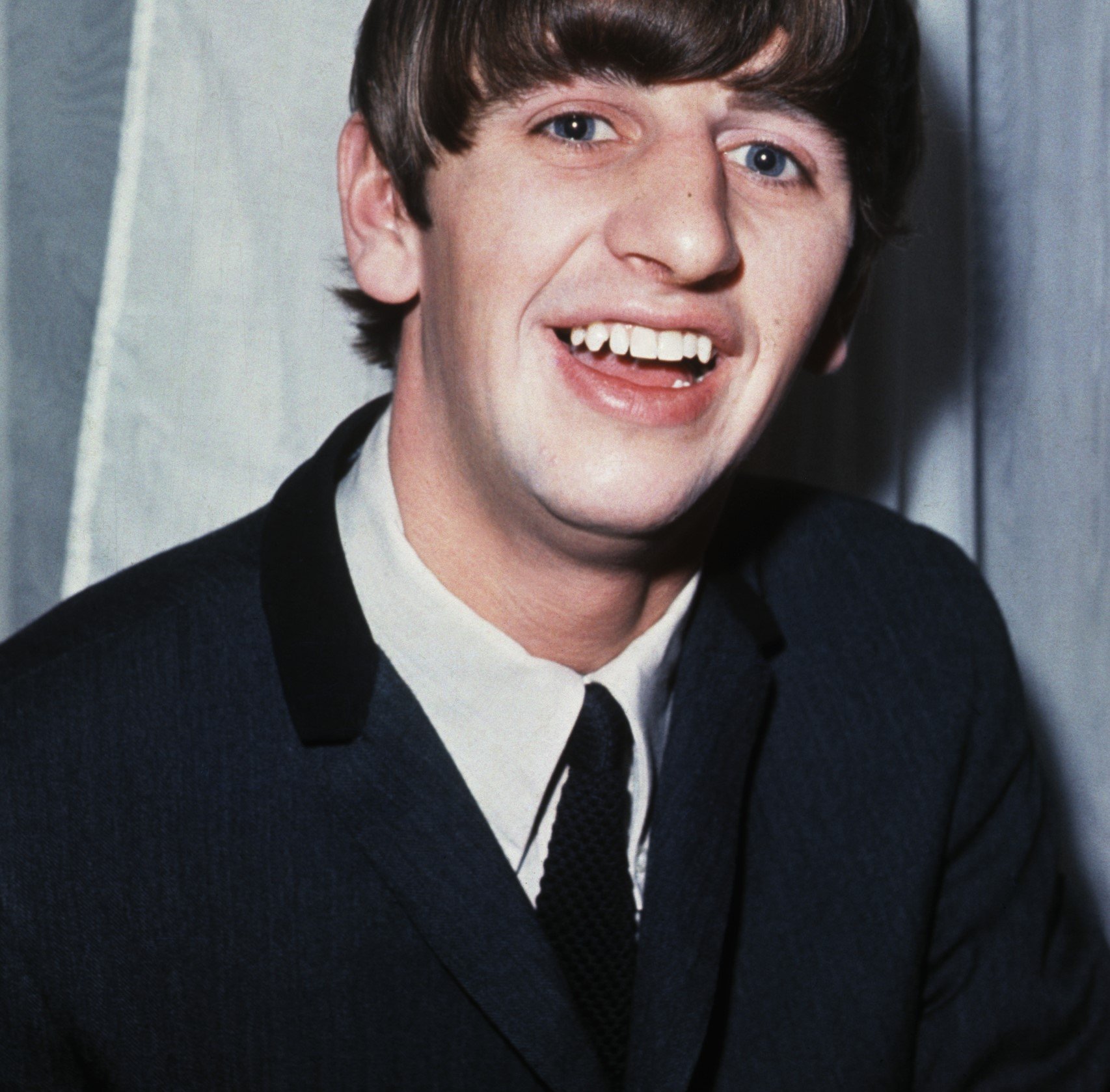 The Beatles' Ringo Starr wearing a black suit
