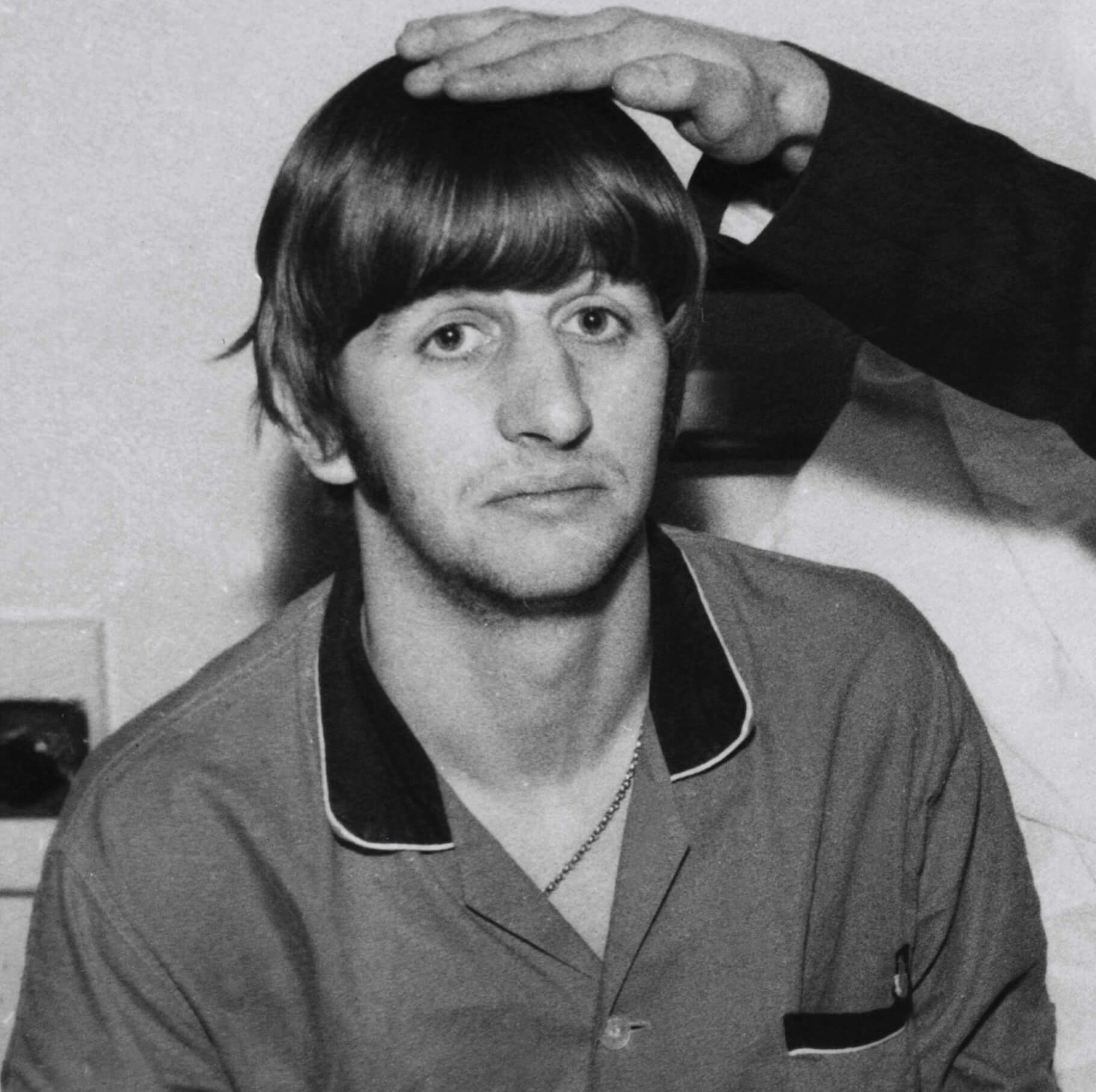 Someone touching Ringo Starr