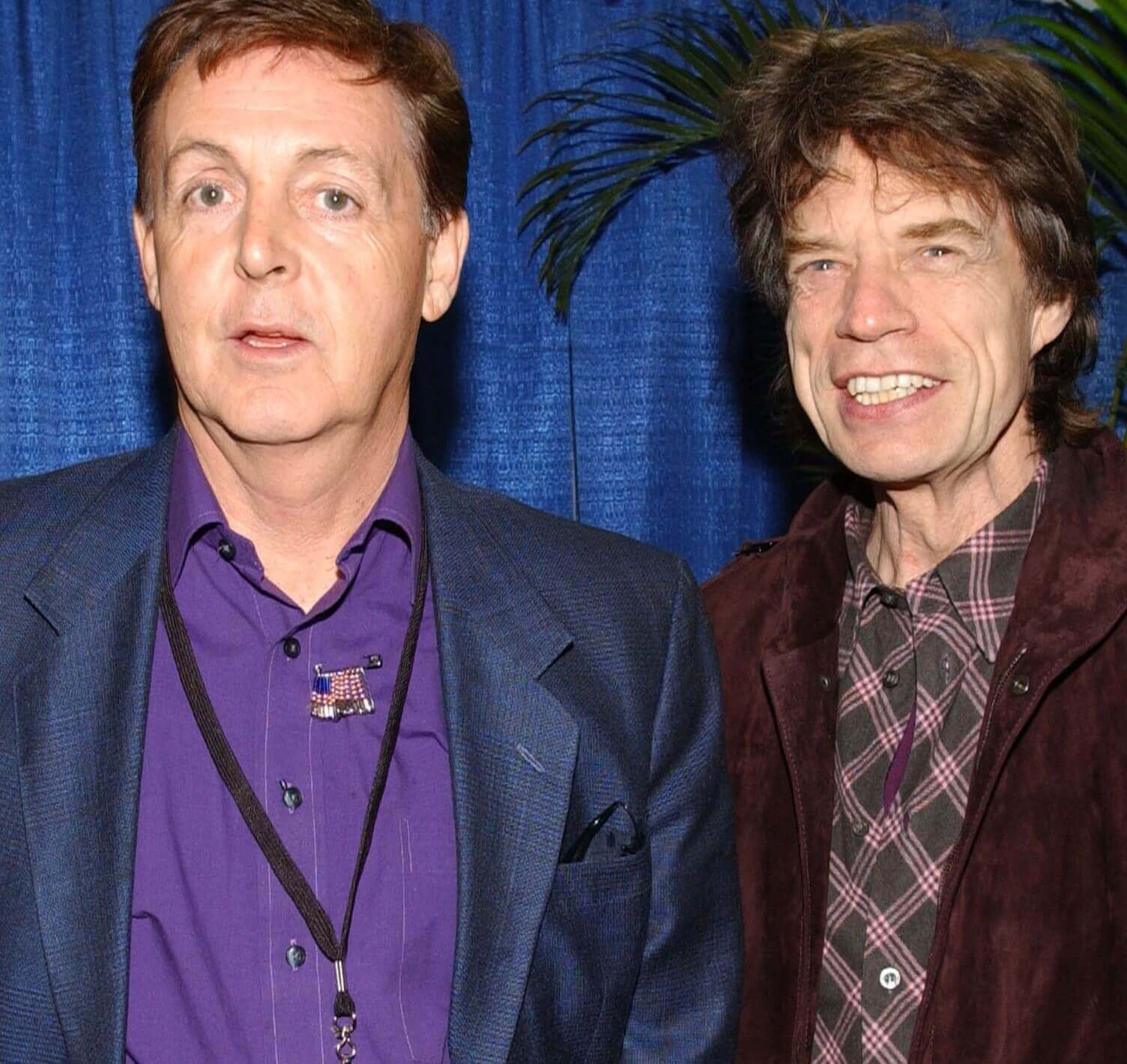 Paul McCartney and Mick Jagger wearing suits