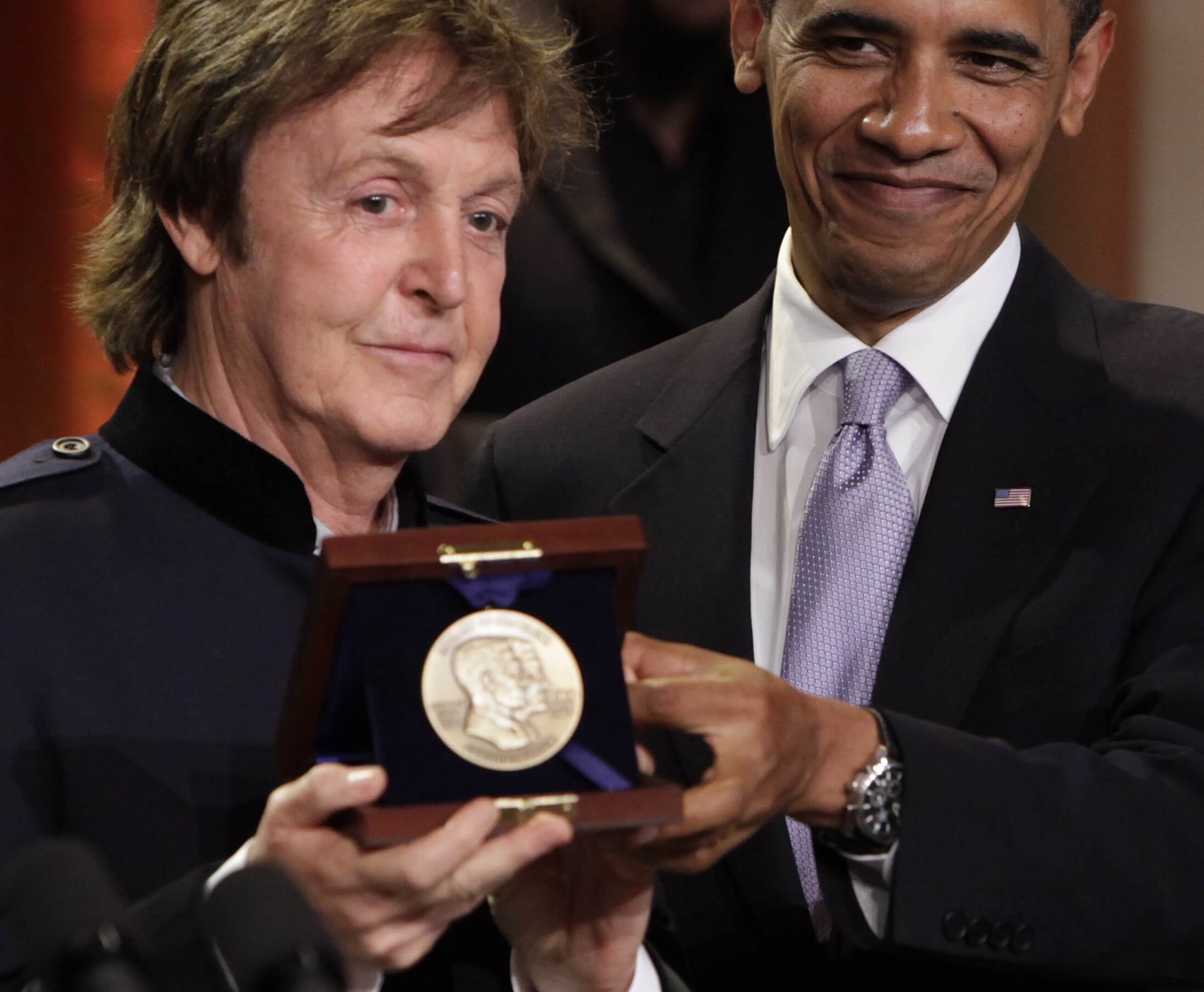Barack Obama handing Paul McCartney an award