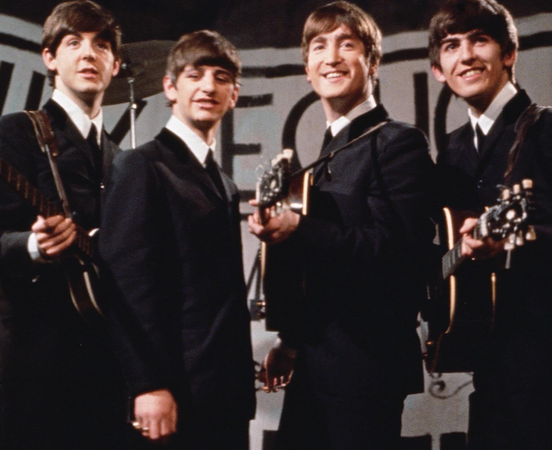 The Beatles wearing black suits