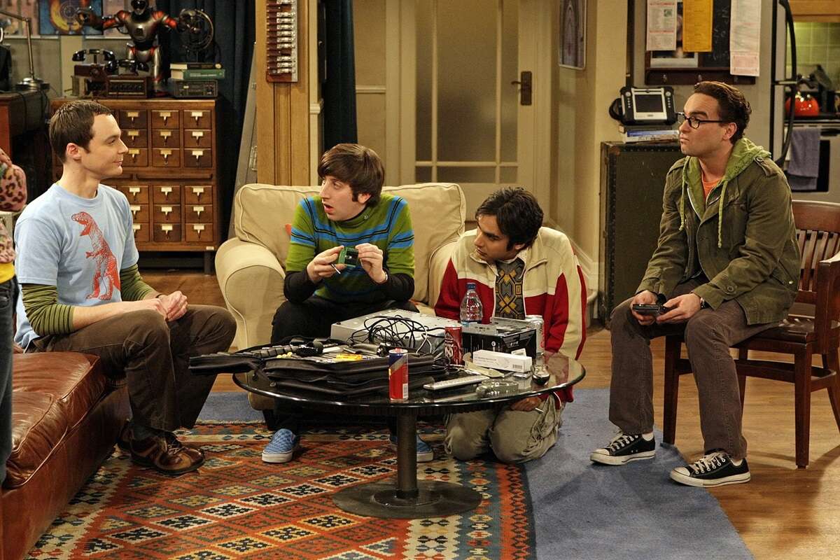 Sheldon, Howard, Raj and Leonard seated together in Sheldon and Leonard's apartment. The core 'The Big Bang Theory' friend group all went to prestigious colleges.