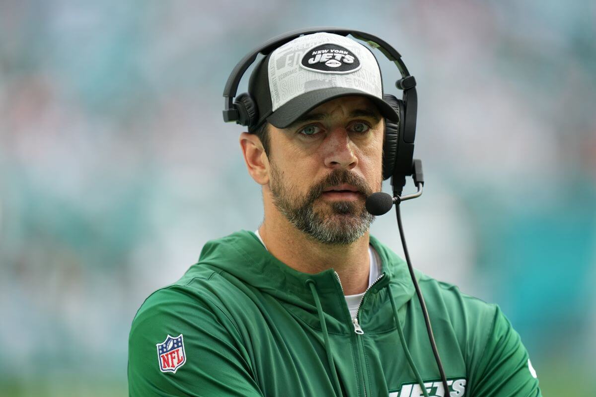 Aaron Rogers on the sidelines with a headset during game between the New York Jets and the Miami Dolphins