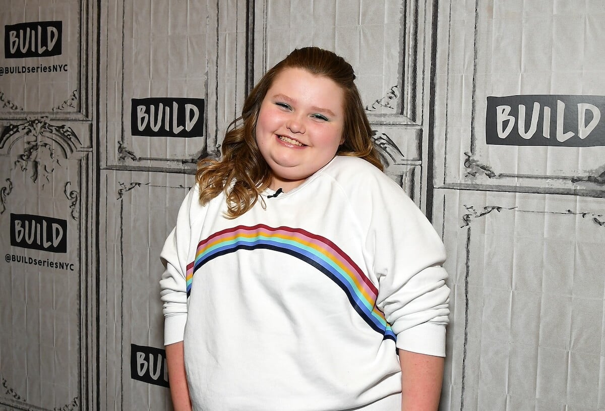 Alana 'Honey Boo Boo' Thompson smiling and wearing a rainbow sweatshirt