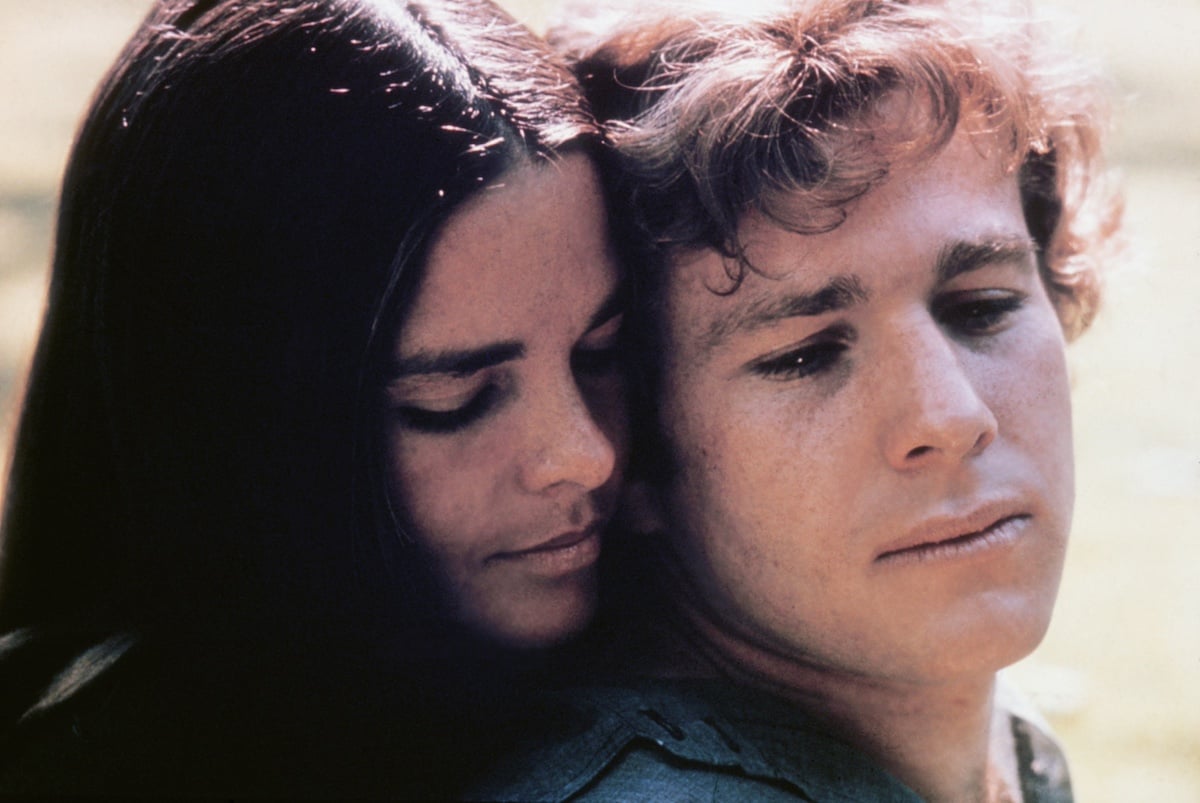 Ali MacGraw embracing Ryan O'Neal from behind in 'Love Story'