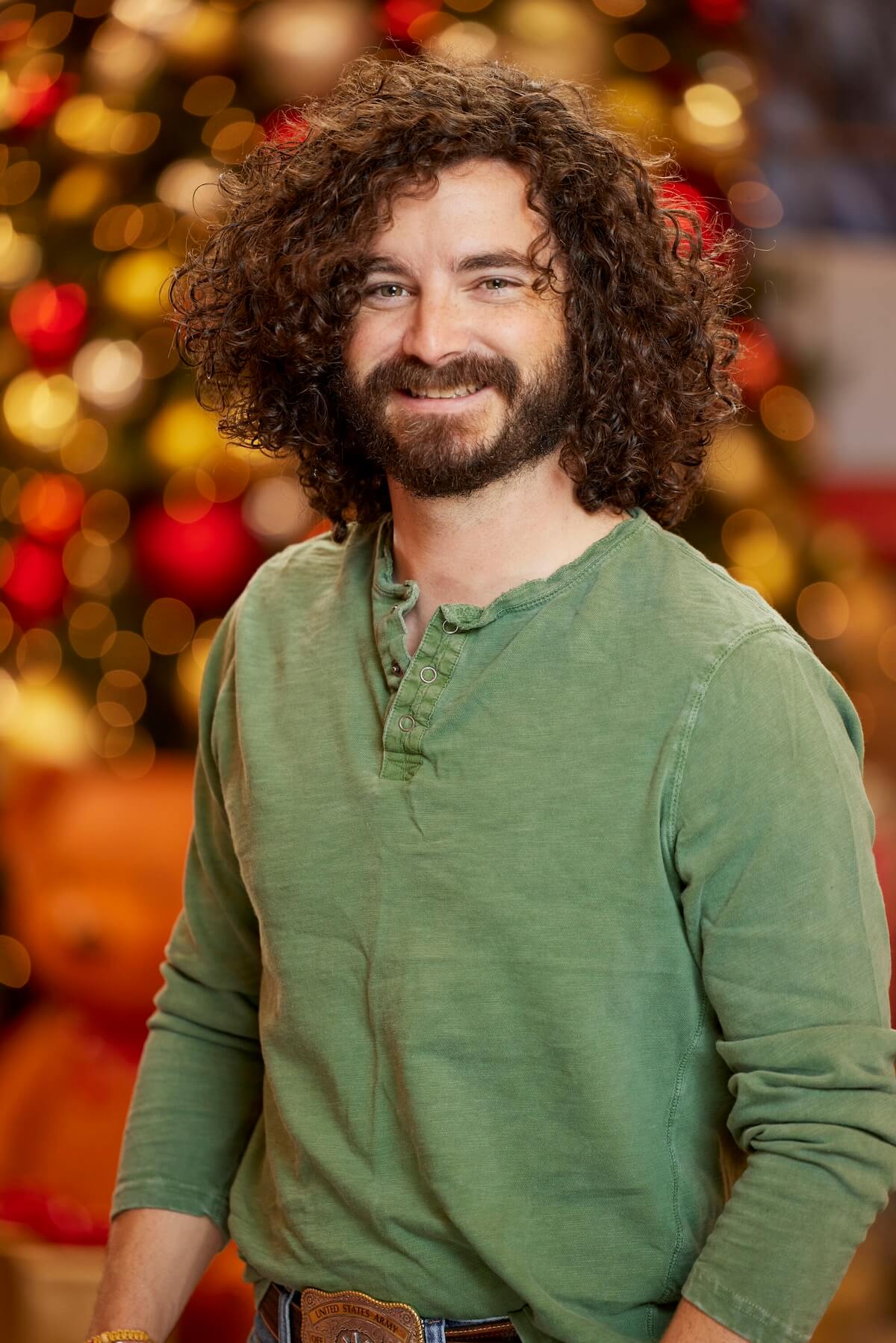 Cameron Hardin of 'Big Brother Reindeer Games' posing in front of Christmas decorations