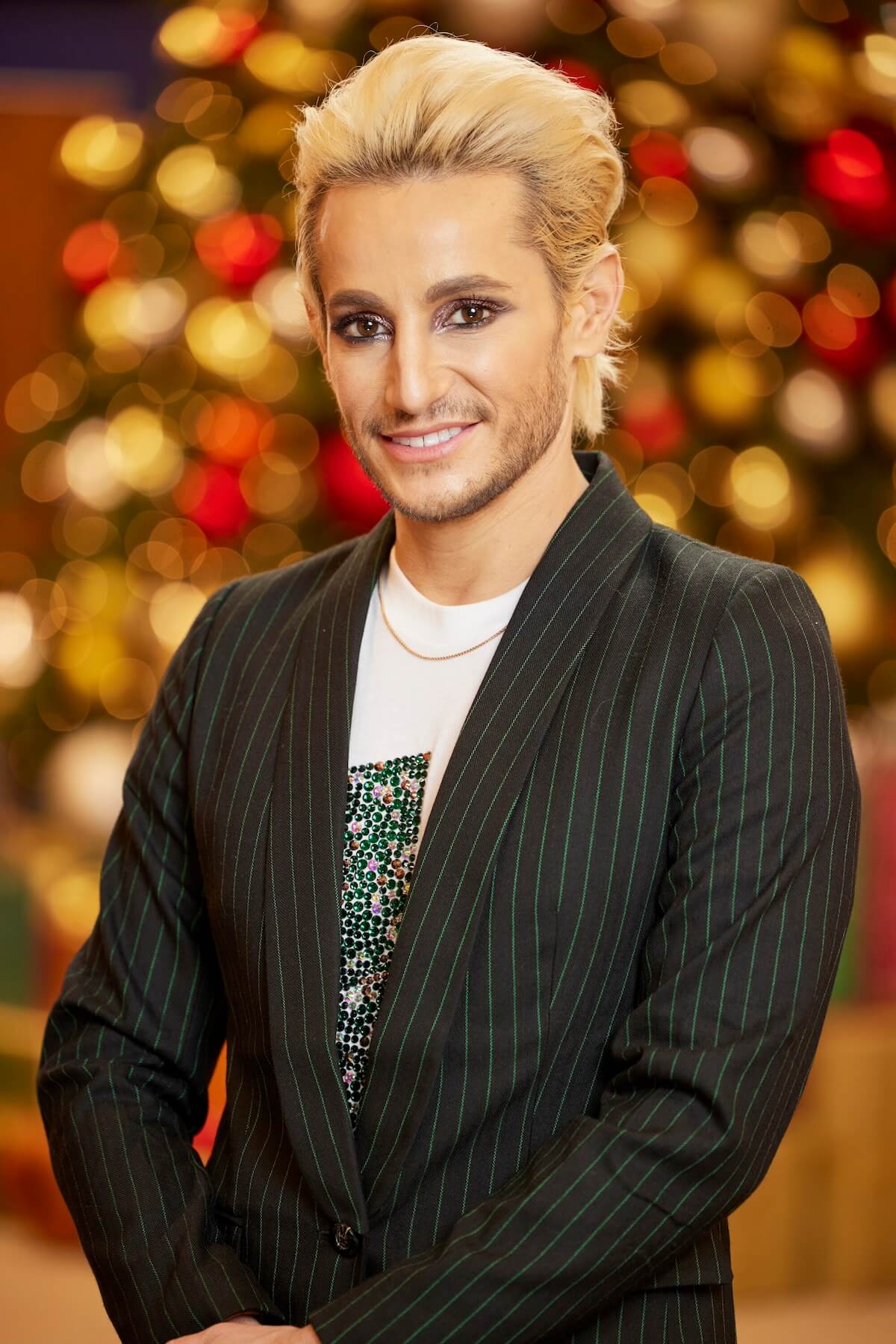 Frankie Grande of 'Big Brother Reindeer Games' posing in front of Christmas decorations